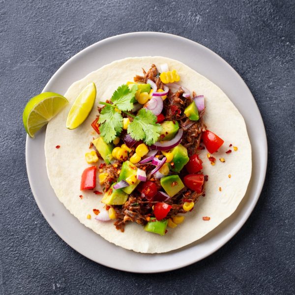 taco with meat and vegetables dark background clos J25EB7V